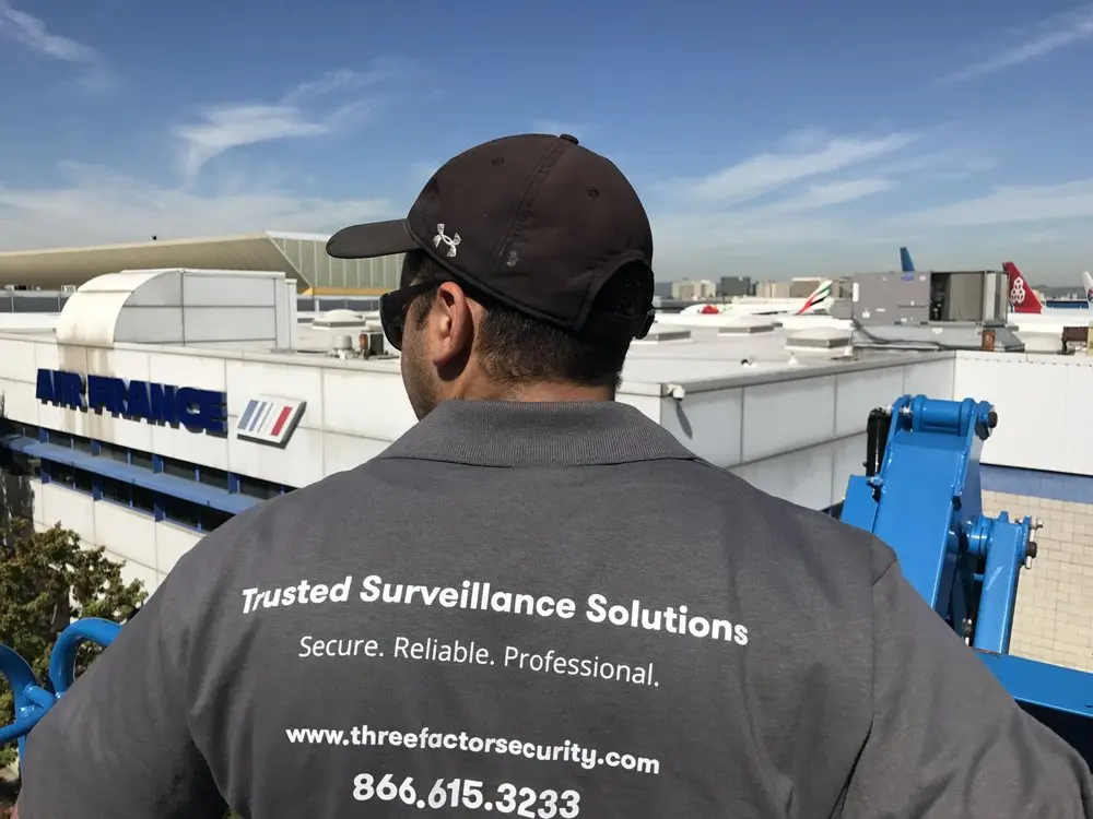 Three Factor Security team member surveying an aviation property near an Air France facility