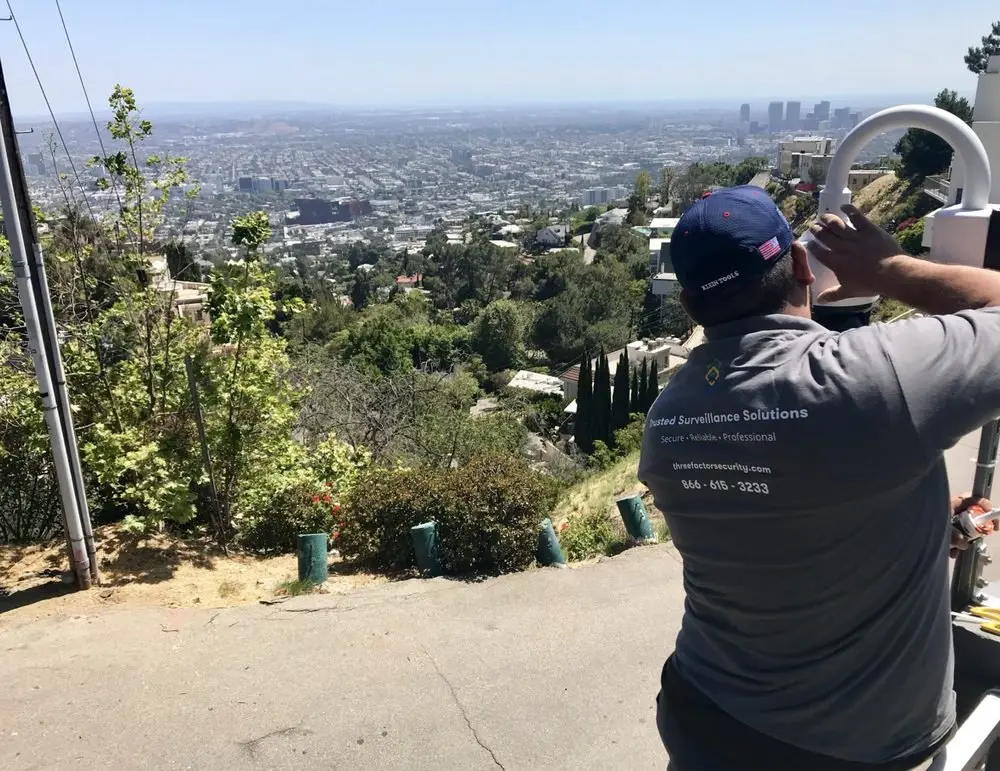 Three Factor Security technician installing a security camera at a luxury hillside home in Hollywood Hills